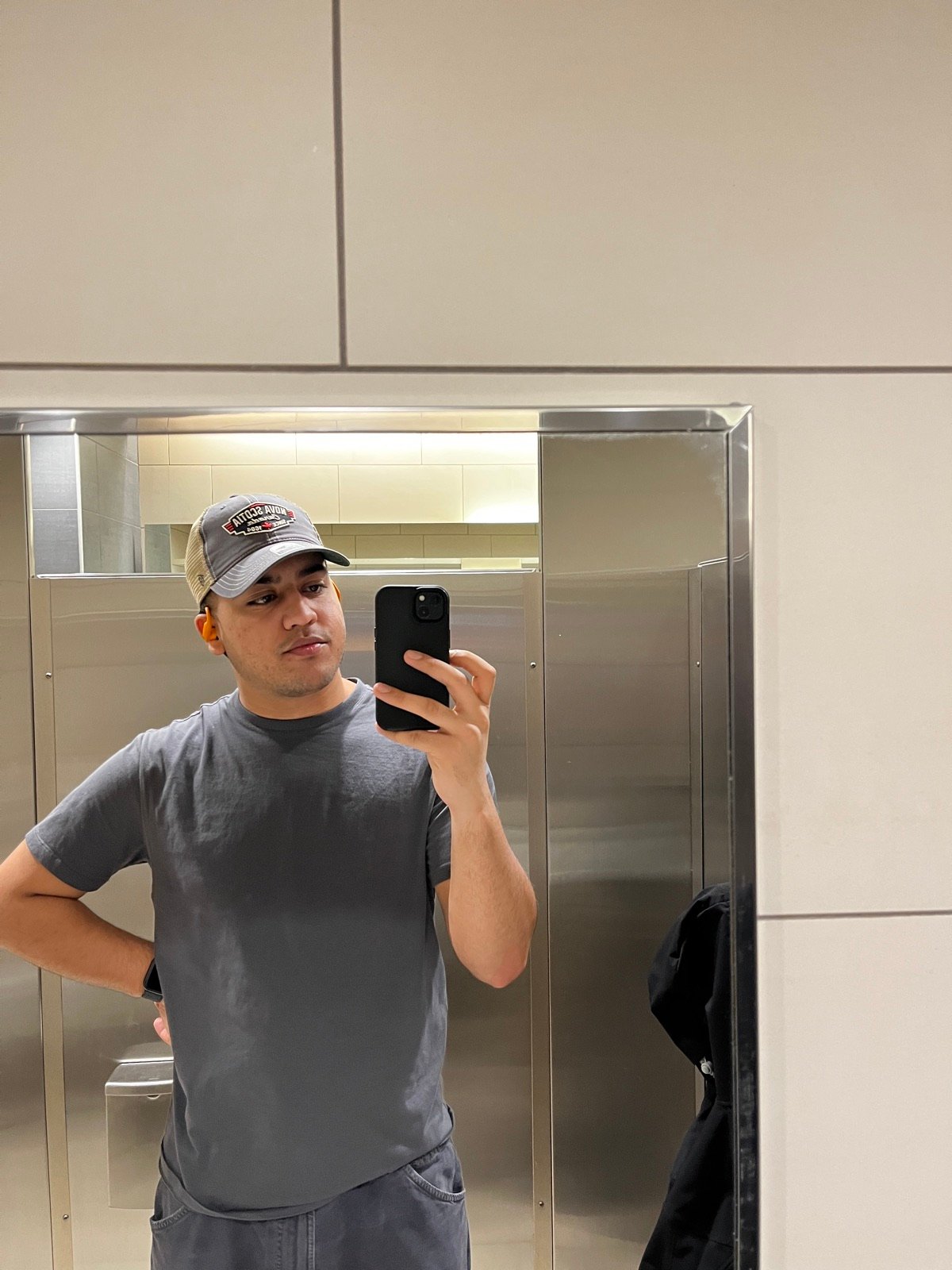 Mirror selfie in a grey tee and a Nova Scotia trucker cap